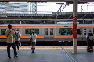 people standing and waiting next train of musashino line of japan railway