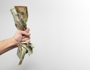 Hand holding a wad of cash
