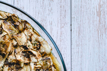 Close up grilled zucchini with garlic sauce homemade organic food in glass bowl