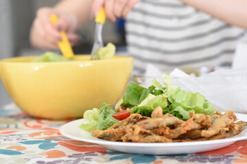 a tasty dish with cooked sardines and lettuce salad