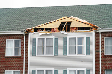 apartment building with damaged roof in repair