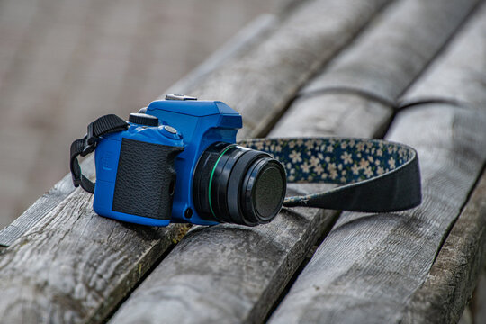 A blue camera on gray boards..