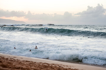 People swimming in the ocean on Oahu Island in Hawaii.