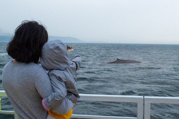 mother and daughter looking at the whale