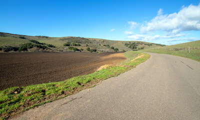 Fototapeta na wymiar Plowed field next to road in Central California near Guadalupe California USA