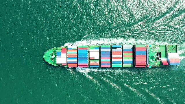 Aerial top view of cargo ship carrying container for import export goods  to customer,concept logistic and supply chain