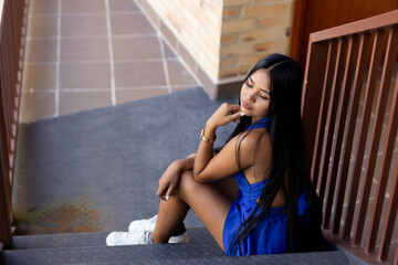 beautiful brunette woman posing on hotel stairs