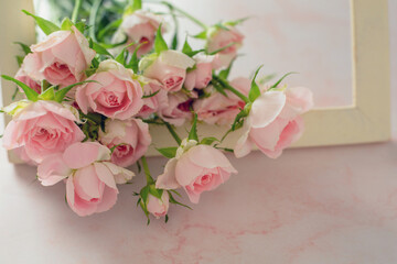 ピンクのバラの花束と白い木のフレーム