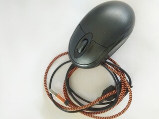 a black mouse with a scrolling string on a white background
