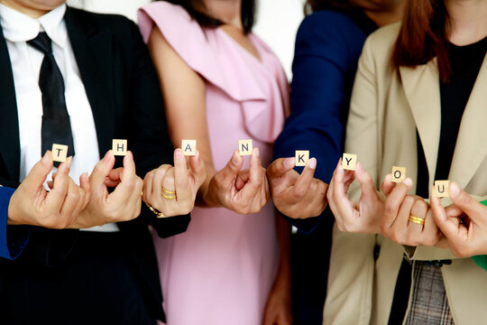 Studio Shot Of Small Wooden Cube Block Thank You Letters Alphabets  Holding By Unrecognizable Unidentified Faceless Female Officer Staff In Business Wears Show Appreciation To Customers Colleagues