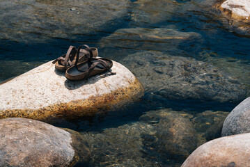 Sandals on river rocks near a river in California. 
