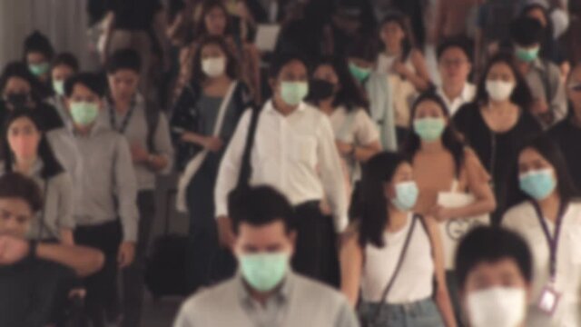 Large crowd of business people with medical face mask. Air pollution. Blurred defocused view of Concept of coronavirus, covid 19 quarantine, 