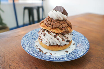 bun ,choux pastry with chocolate powder topping or eclair