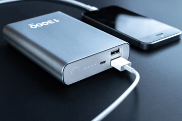 Power bank charger. Portable powerbank with white usb cable for charger mobile phone or smartphone...