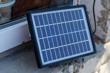 Solar panel on windowsill. Small solar battery. Charging your la