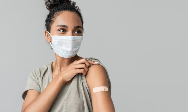 Woman showing her arm with bandage after receiving covid vaccination. Corona virus protection, self care, healthy lifestyle concept - Powered by Adobe