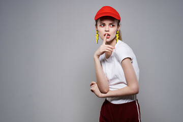 cheerful pretty woman in red cap fashion earrings jewelry summer style