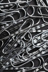 Silver paper clips textured background full screen