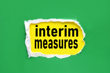INTERIM MEASURES, text on torn paper. test in black letters