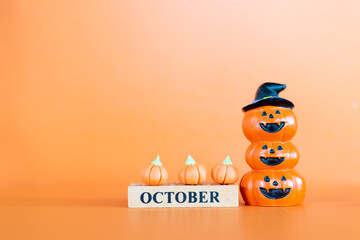 Fototapeta premium Halloween pumpkins on orange background, Hello October concept