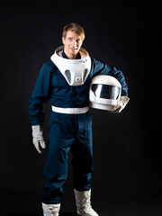 An astronaut or a space tourist. A young man in a spacesuit
