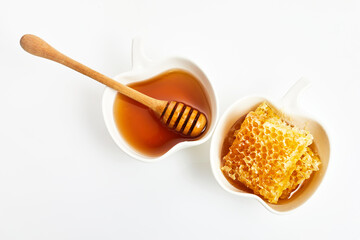 Honey and fresh honeycombs on table, top view