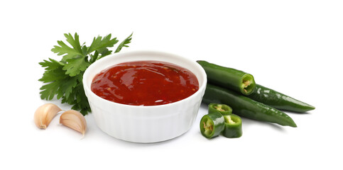 Spicy chili sauce and ingredients on white background
