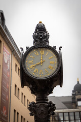 an old historical clock with golden dial in a small alley in Dresden in the Münzgasse.