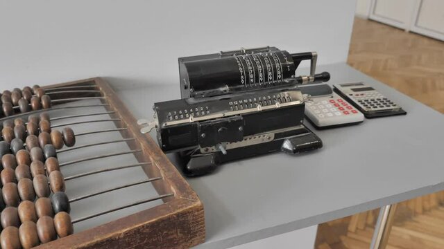 Old Fashioned Calculators Near Adding Machine And Counting Frame
