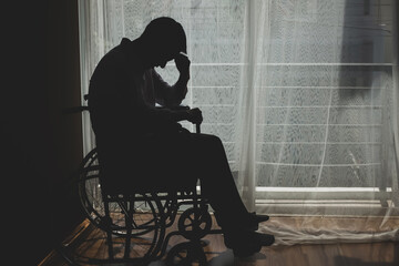 Sad  guy in a wheelchair which he feeling  depressed  Cry, drama, lonely and unhappy concept.