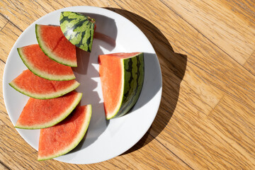 Slices of a red juicy watermelon on a plate 