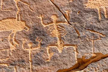 A petroglyphic image of humans with anatomical details, Graffiti Rocks (Qaryat al Asba),...