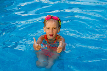 Fototapeta na wymiar Happy child in the pool. Summer vacation concept