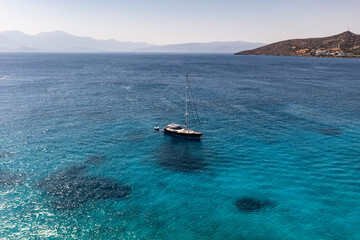Obraz premium panoramic view of the sea and mountains and ships on turquoise water filmed from a drone
