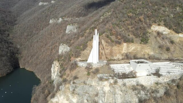Aerial view of Memorial of Rhodope partisan detachment Anton Ivanov at the coast of The Vacha Reservoir,  Bulgaria
