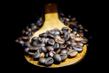 Hot roasted coffee on a black background.