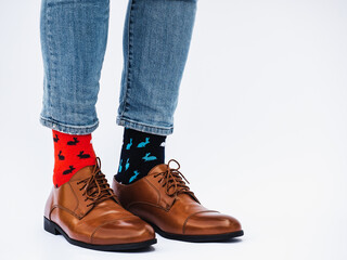 Men's legs, trendy shoes and bright socks. Close-up. Style, beauty and elegance concept