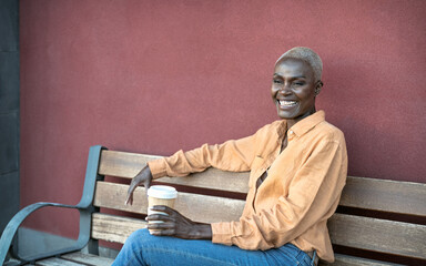 African senior woman drinking coffee outdoor