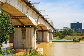 A sand dredger passes through the river-crossing bridge hole