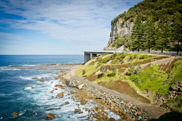 View along Sea Cliff Bridge, Sydney South Coast. New South Wales Australia. Road against ocean, cliff and sky. No people.