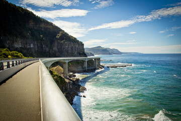 View along Sea Cliff Bridge, Sydney South Coast. New South Wales Australia. Road against ocean,...