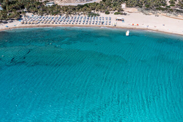 panoramic view of the sea and mountains and a boat on turquoise water filmed from a drone 