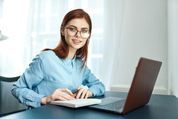 woman sitting at a table in front of a laptop learning disorder fatigue