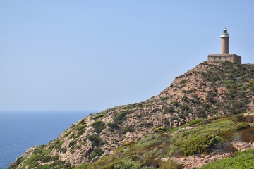 Fototapeta na wymiar lighthouse on the rock of cape sandalo, San Pietro island, Sardinia, Italy