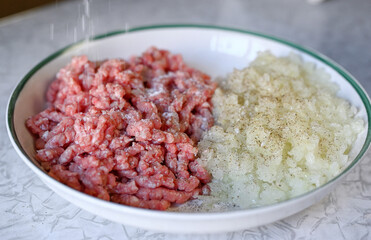 Step by step instructions. Step two. How to make a puff pastry product with meat at home. Season with salt and pepper the minced meat and chopped onion.