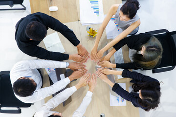 Business people put hands together.