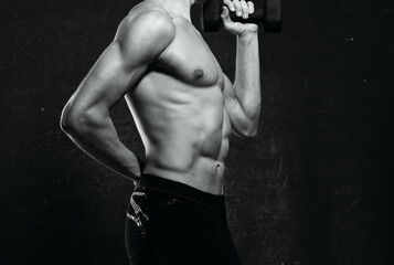 Fototapeta na wymiar sporty man naked torso inflated body posing dark background