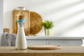 Fresh cold milk in bottle and kitchen interior. Free space for your decoration 