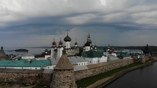 A slow flight near the walls and towers of the Solovetsky Kremlin on a cloudy day with soft lighting. This is part of the fortress of the Solovetsky monastery - an old (1420) ROC monastery.