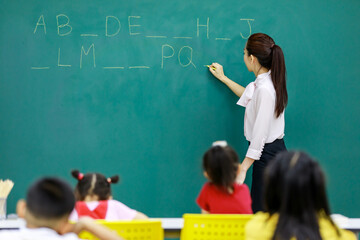 Portrait shot of Asian young beautiful female English language professor teacher lecturer standing...